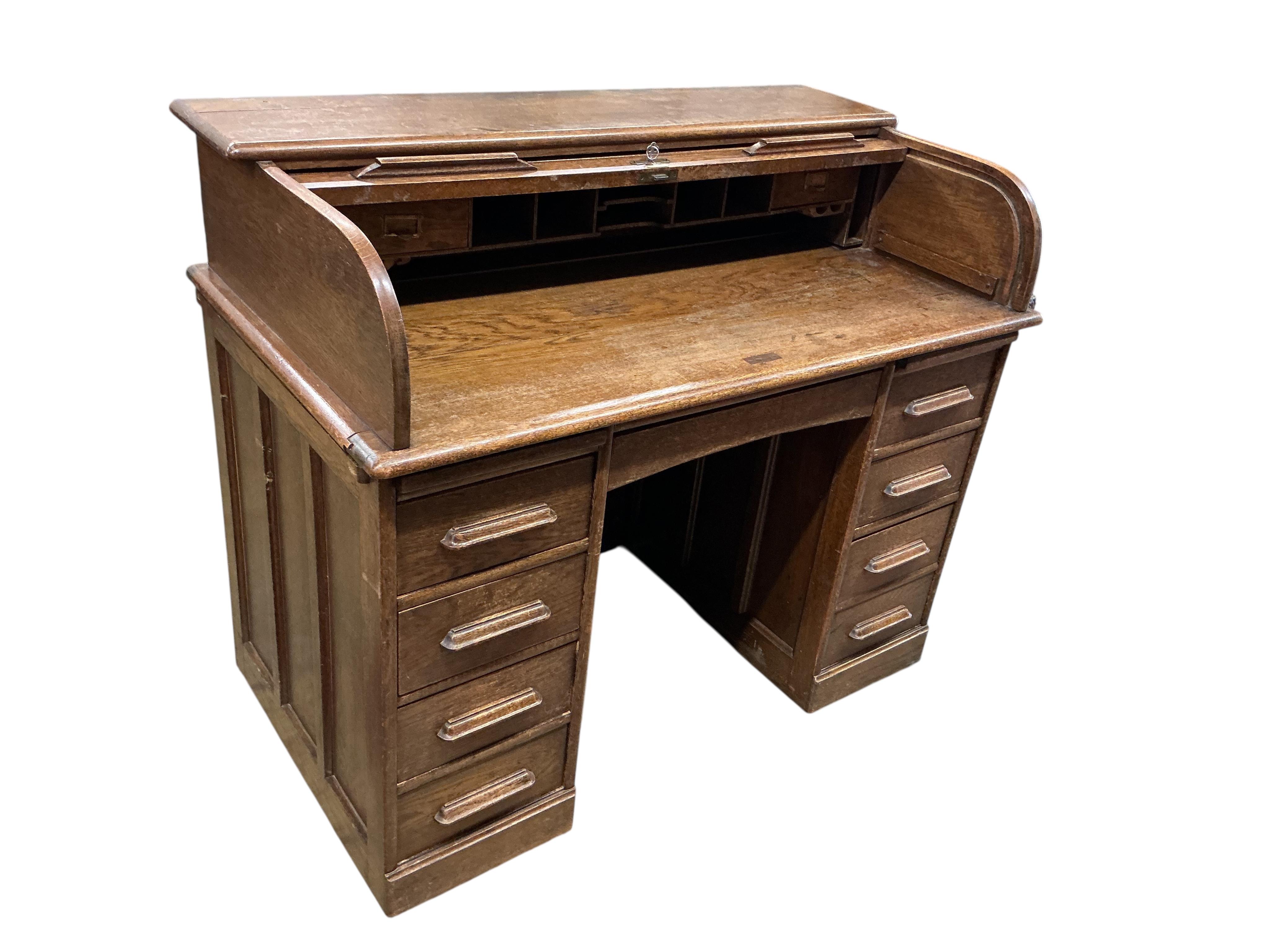 An early 20th century oak roll top desk, width 122cm, depth 66cm, height 101cm
